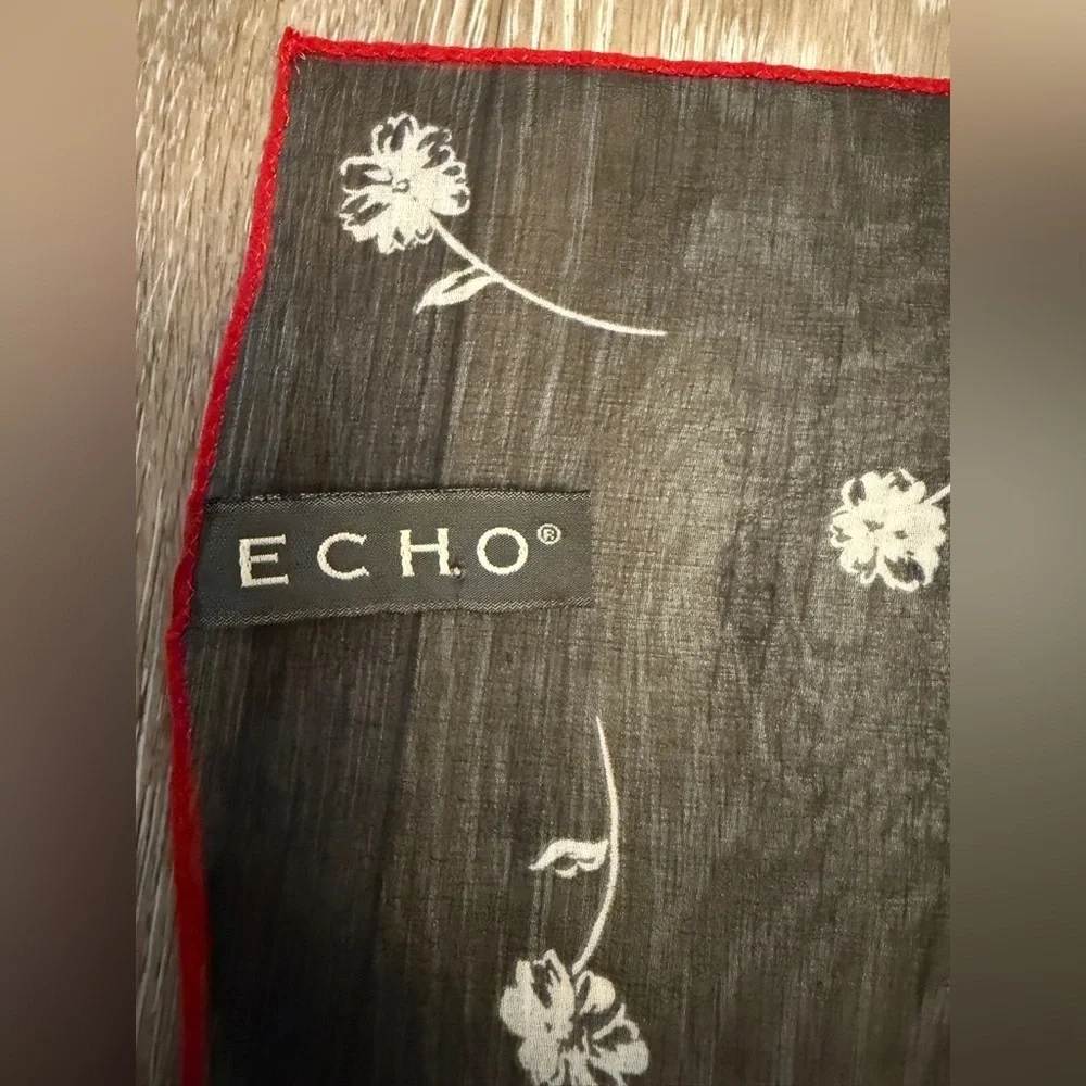 ECHO Small Black Sheer and stretch Scarf with white floral and red outline.